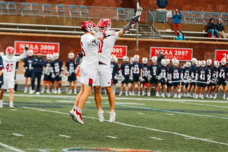 Daniel Picart celebrates with a teammate during Richmond's 17-2 home-opener win on February 8, 2025