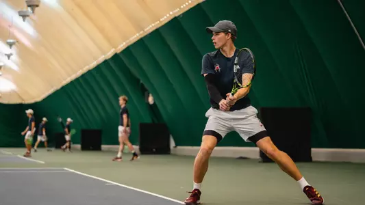Davis Wiley returning a serve