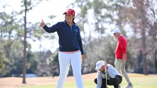 Maya Beasley gives a teammate a thumbs up on the putting green