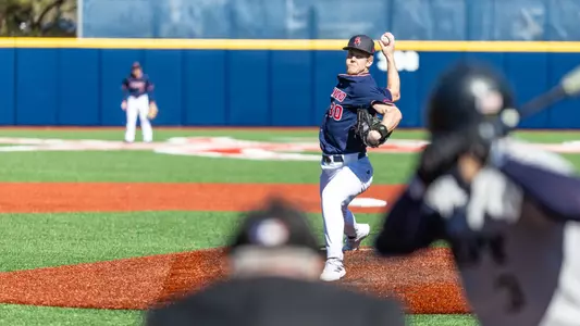 Ryan Bilka throws the ball towards the batter at home plate