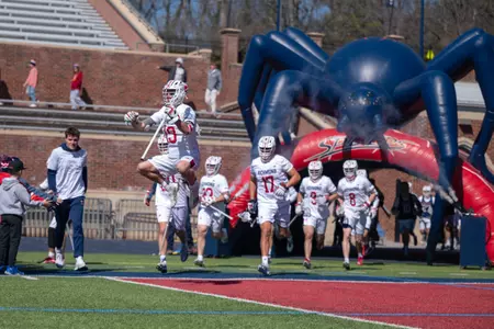 Jack Pilling leaps in the air as he runs out of the tunnel after Richmond's game against Cornell on March 2, 2025