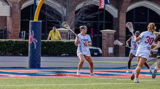 Elizabeth Darcy feeding from behind goal