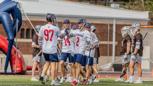MLAX celebrating goal vs St. Bonaventure