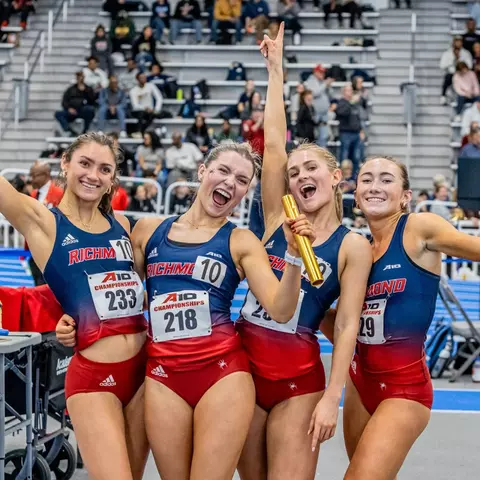 A Spider relay team reacts after winning gold at the A-10 championships