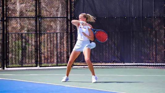 Lainey O'Neil returning a serve