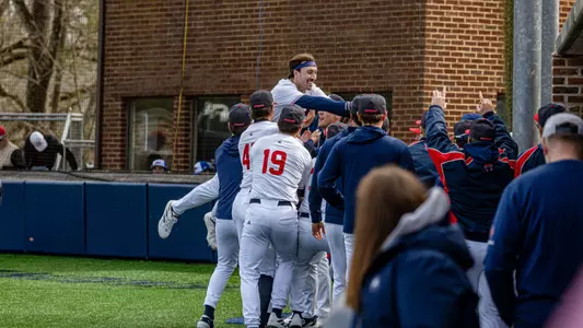 Jordan Jaffe celebrates his home run by jumping into the arms of his teammates
