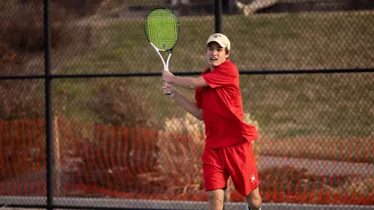 Dylan Atkinson returning a serve