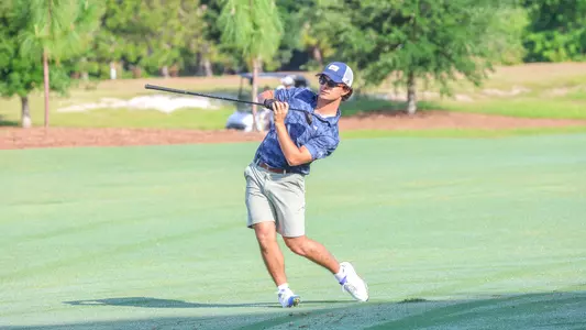 Carson Baez stands on his tiptoes after a tee shot