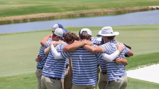 The Spiders huddle on the green