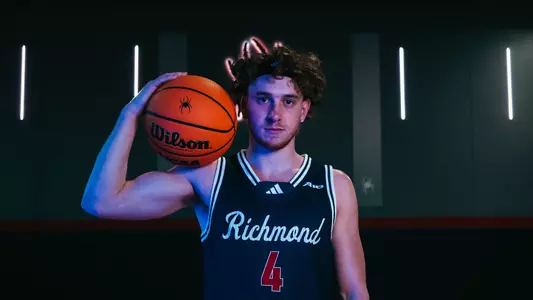 Will Johnston poses with a basketball on his shoulder in the QAC