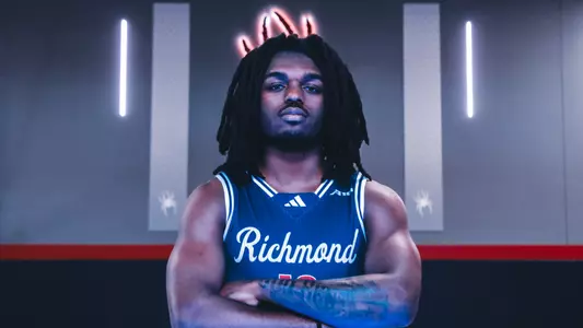 David Thomas poses in front of a Spider in the QAC