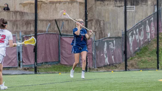 Whitney Liebler feeds from behind cage