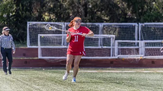 Colleen Quinn moving ball around the cage