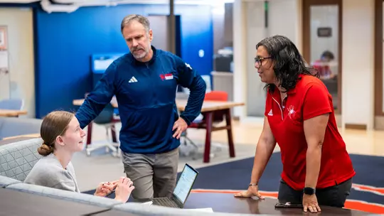 Bruce Matthews and Courtney Hughes discuss classwork with a student