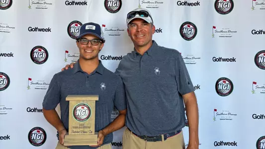 Carson Baez poses with coach Adam Decker and the NGI runner-up trophyj