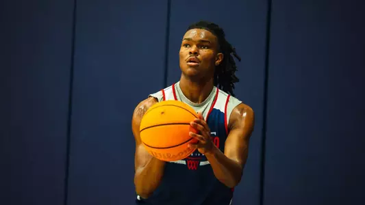 Collin Tanner prepares to shoot a three-pointer from the corner