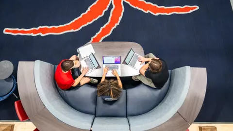 An overhead view of three students studying in Millhiser Academics Center