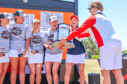 Members of the women's golf team react after winning the 2025 A-10 Championship