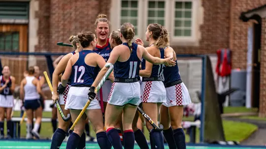 Richmond huddles to celebrate scoring a goal against Davidson