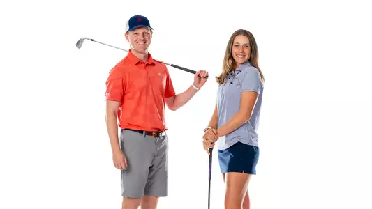 Cole Ekert and Hannah Lydic pose with golf clubs in front of a white background