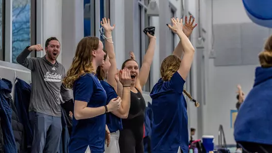 Swimming and diving celebrating 200 medley relay win at 2025 A-10s