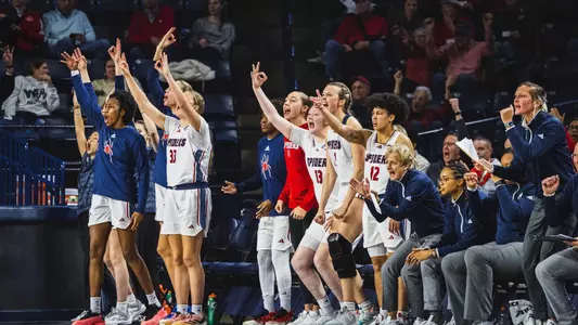 Women's basketball celebrating on the bench
