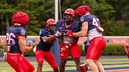 Amir Haskett celebrates an interception in the end zone during a Richmond football practice