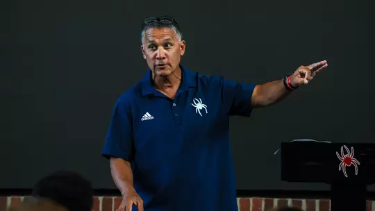 Spider baseball coach Mik Aoki addresses a banquet