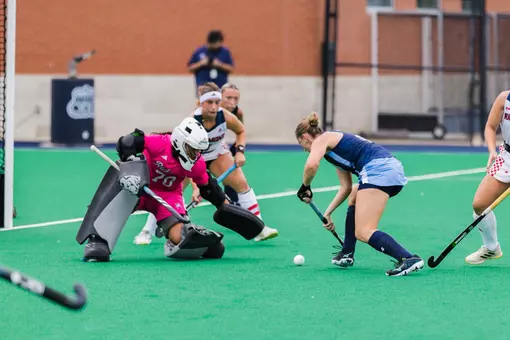 Spider Field Hockey goalkeeper Amanda Cimillo, in pink, takes the ODU attacker one-on-one in the circle.