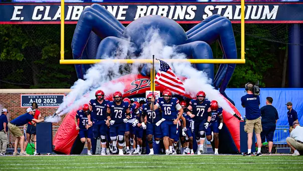 Football team running out of the tunnel at Robins Stadium. on Sept. 20, 2025