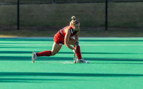 Spider field hockey's Alexa Derr passes the ball across the field