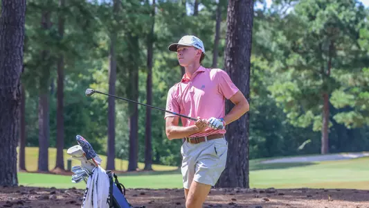 Drew Carlin holds his follow-through after a fairway wood