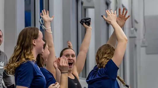 Erin Budde and Team celebrating relay win at 2025 A-10s