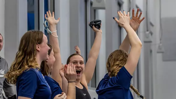 Erin Budde and Team celebrating relay win at 2025 A-10s