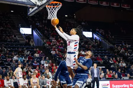 Will Harper III makes a layup over two defenders