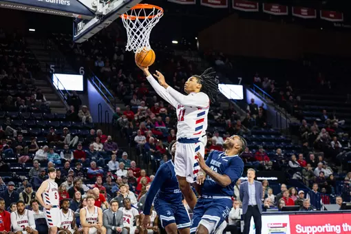 Will Harper III makes a layup over two defenders