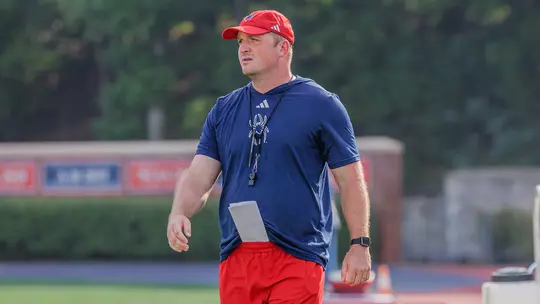 Jacob Huesman coaching during a Richmond football practice