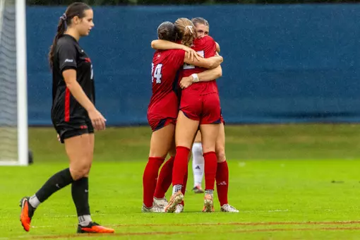 Spider teammates celebrate after defeating Davidson