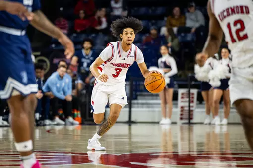 Aiden Argabright dribbles the ball up the court vs URI