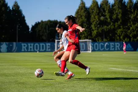 Emma Newman battles a Rhode Island defender for the ball
