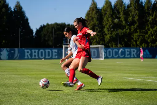 Emma Newman battles a Rhode Island defender for the ball