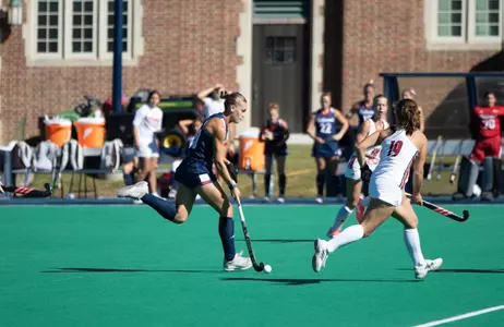 Clara Larripa drives the ball through Louisville defenders
