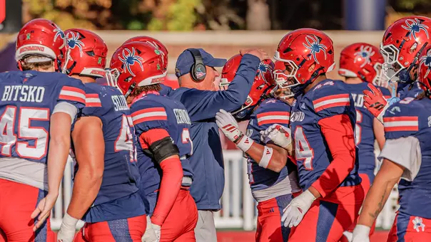 Head Coach Russ Huesman celebrates Jeremiah Washington's interception with him during Richmond's 13-6 win over Colgate on ct. 24, 2026