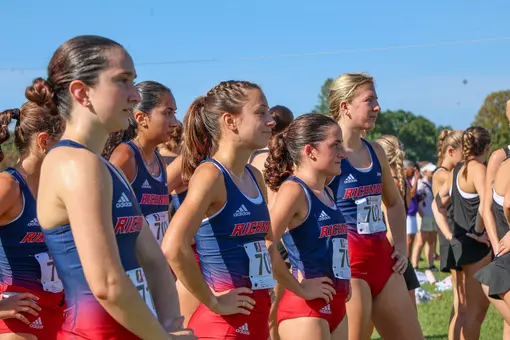 Members of the women's cross country team wait at the start line
