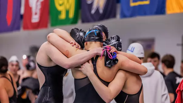 Richmond swim team huddling during the 2026 Atlantic 10 Championships