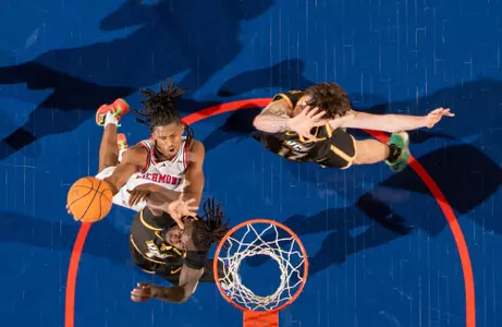An overhead shot of AJ Lopez making a layup over two VCU defenders