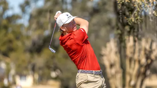Parker Moellinger stares down his tee shot