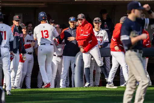 The dugout high-fives Dylan Winebrenner as he returns after scoring