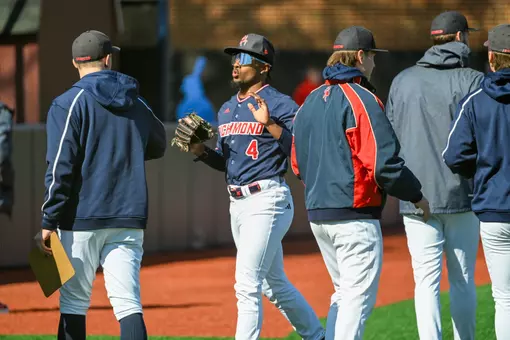 RJ Johnson Jr high fives his teammates come into the dugout