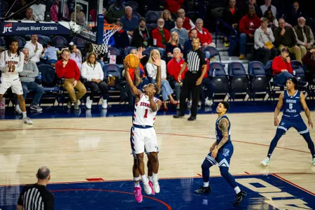 Mikkel Tynes shoots a reverse layup against Rhode Island